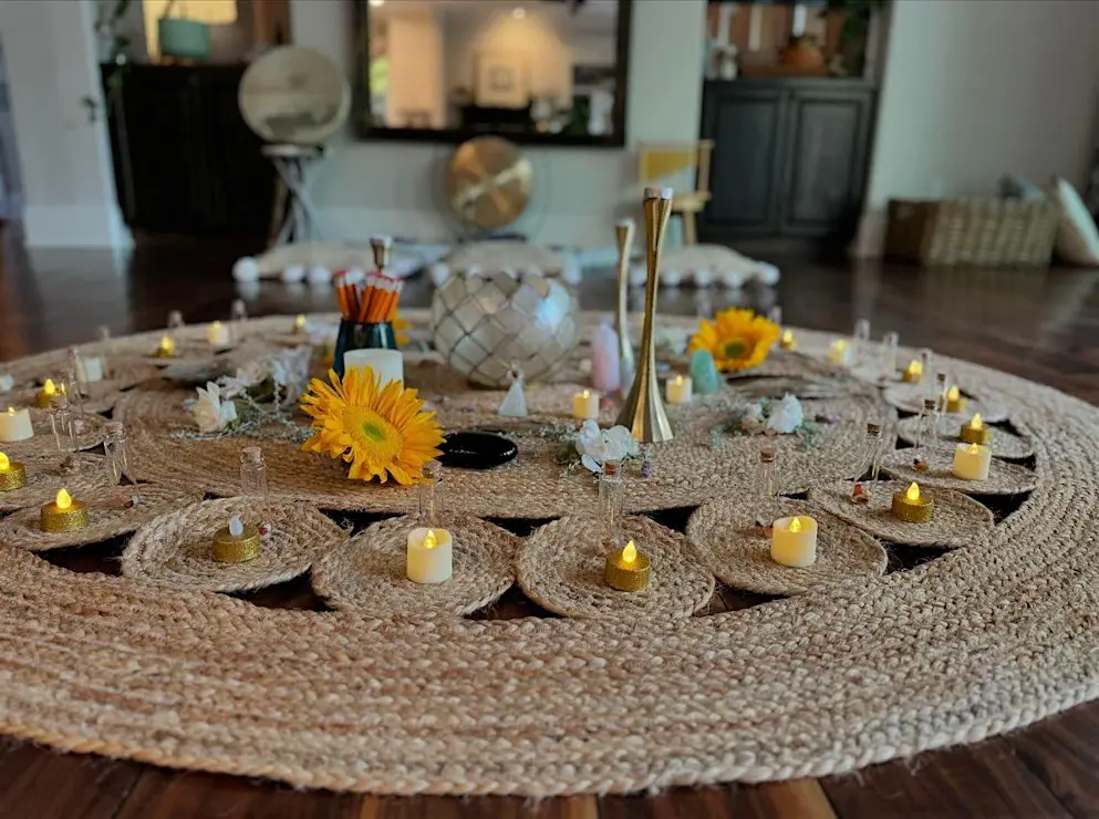 A woven altar with sunflowers, candles, and crystals