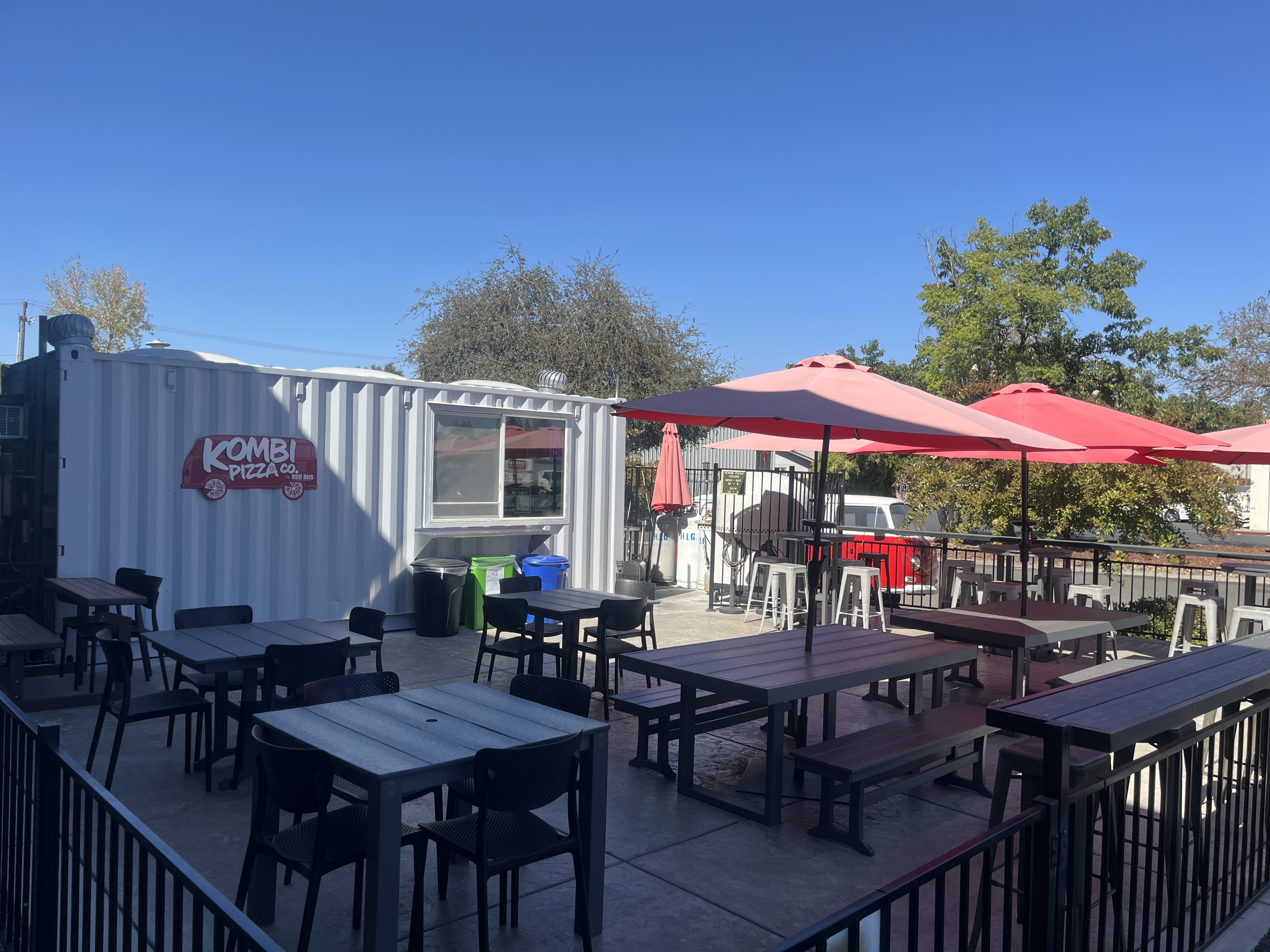 The outdoor patio at Red Bus Brewing Company with red umbrellas