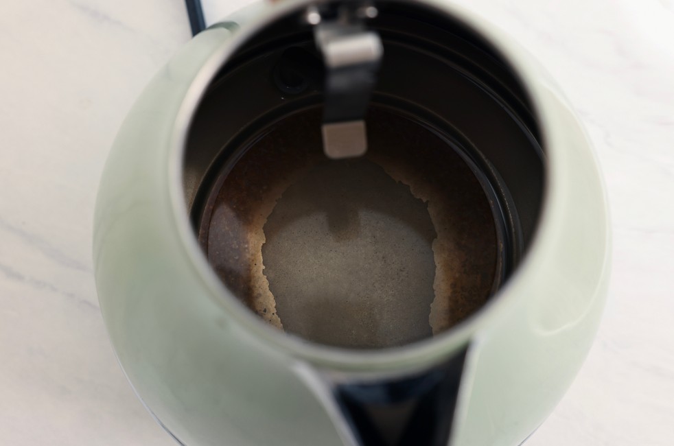 Limescale buildup inside a kettle affecting water usage at home