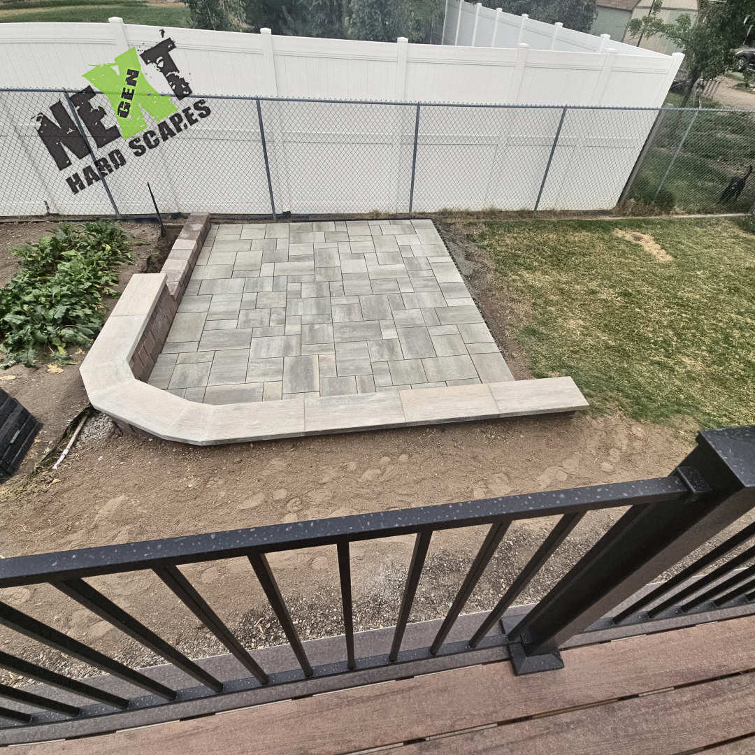 A look down at the beautiful paver-patio from the new deck. 
