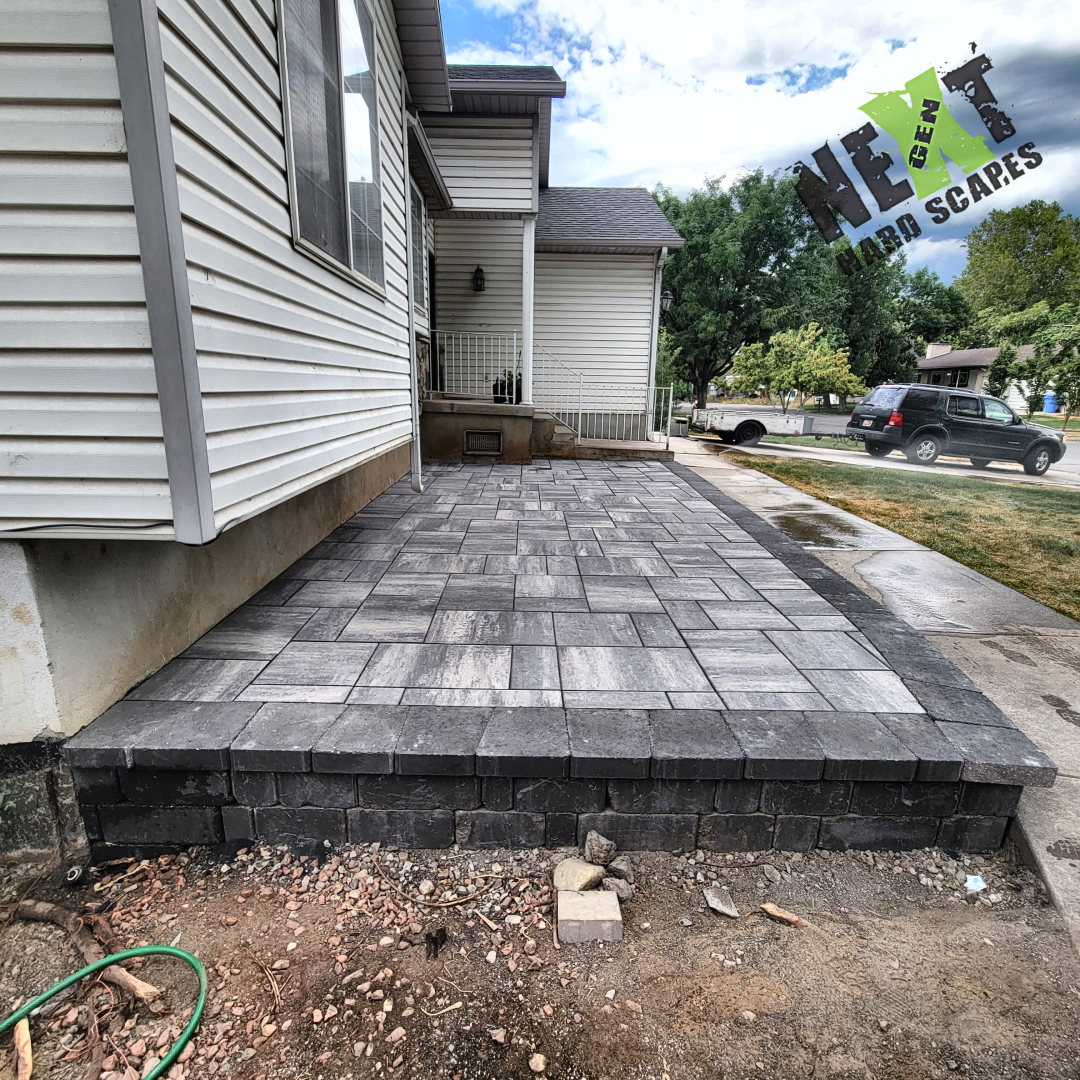 Side view of the front porch with fully installed pavers and neatly stacked edge bricks ensuring structural integrity. Side view of the front porch with fully installed pavers and neatly stacked edge bricks ensuring structural integrity.