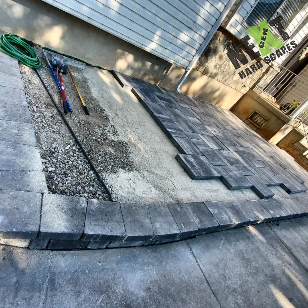 Early phase layout showing the base layer preparation and precisely positioned border pavers forming the foundation. Early phase layout showing the base layer preparation and precisely positioned border pavers forming the foundation.