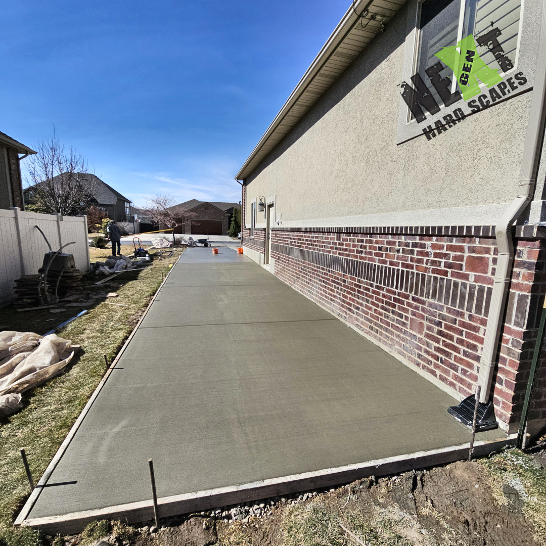 Fresh concrete being poured and carefully leveled by hand, demonstrating precise control over the material placement.