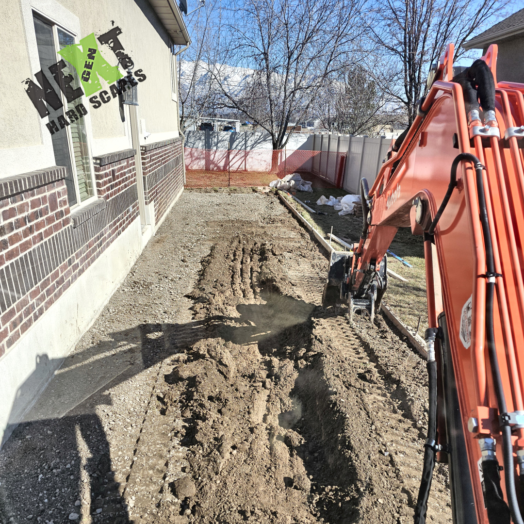 Early excavation underway, showing even removal of soil within the framed area and preparation for base gravel placement.
