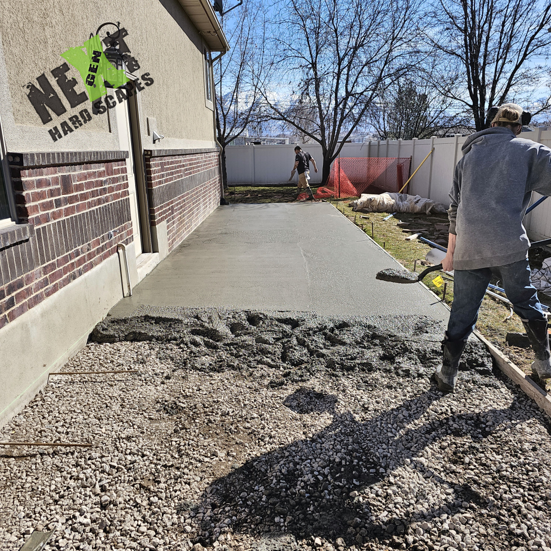 Plate compactor positioned to further stabilize and compact the gravel base, creating a firm foundation before concrete pours.