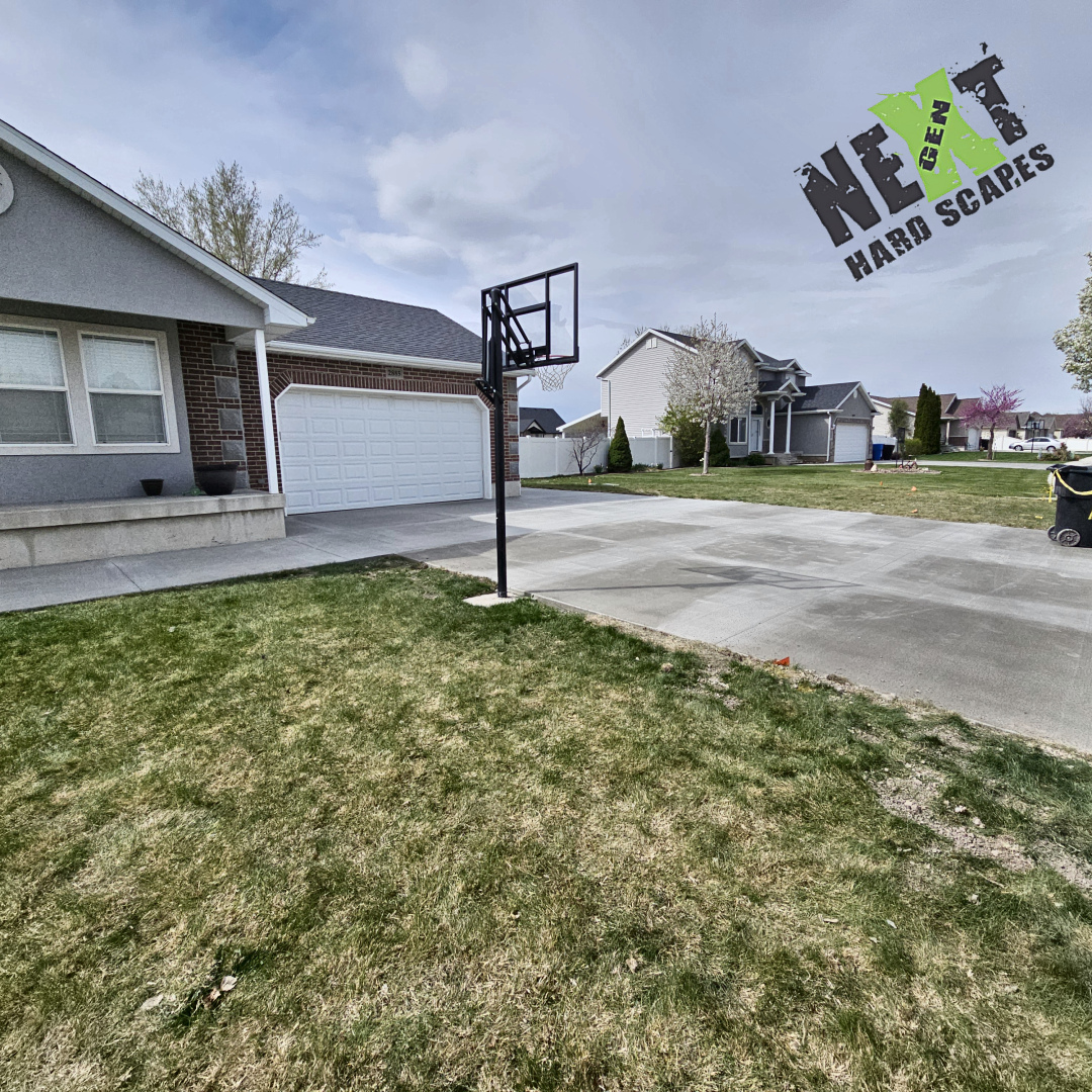 Final views of the completed driveway illustrate the craftsmanship in uniform surface finish, precise perimeter formwork, and alignment with landscaping.