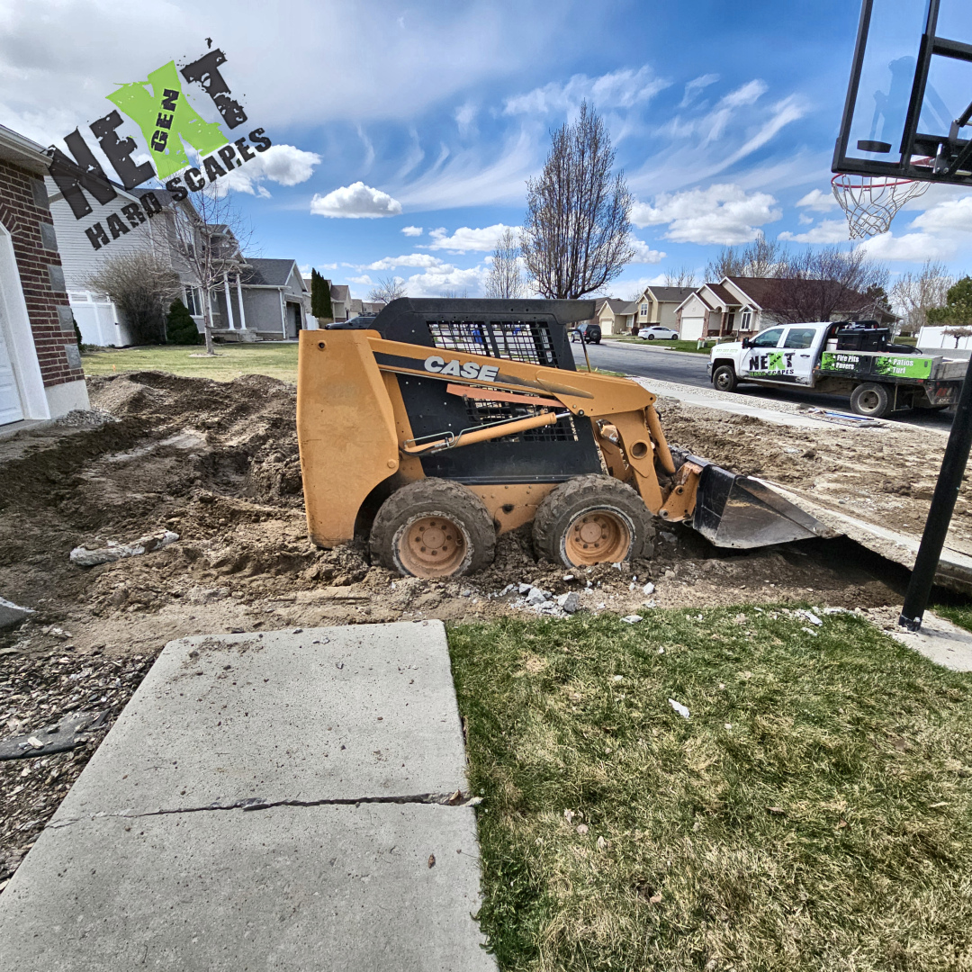 Removal of the old driveway in process. Mindful of existing elements like a basketball hoop, and the lawn. 