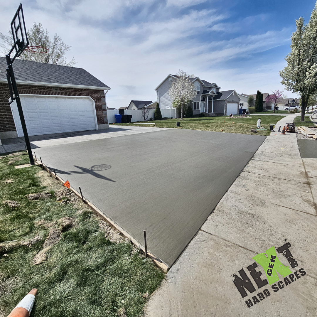 The lower section of driveway and park strip freshly poured and screeded flat for a consistent, durable surface that ties neatly into the neighborhood sidewalks.