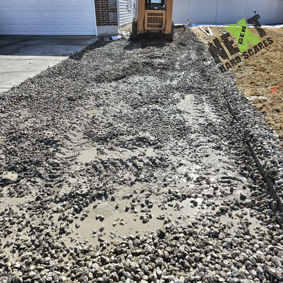 Gravel base and leveling stones are set in place, providing a firm foundation to maintain consistent thickness and support for the upcoming concrete pour.