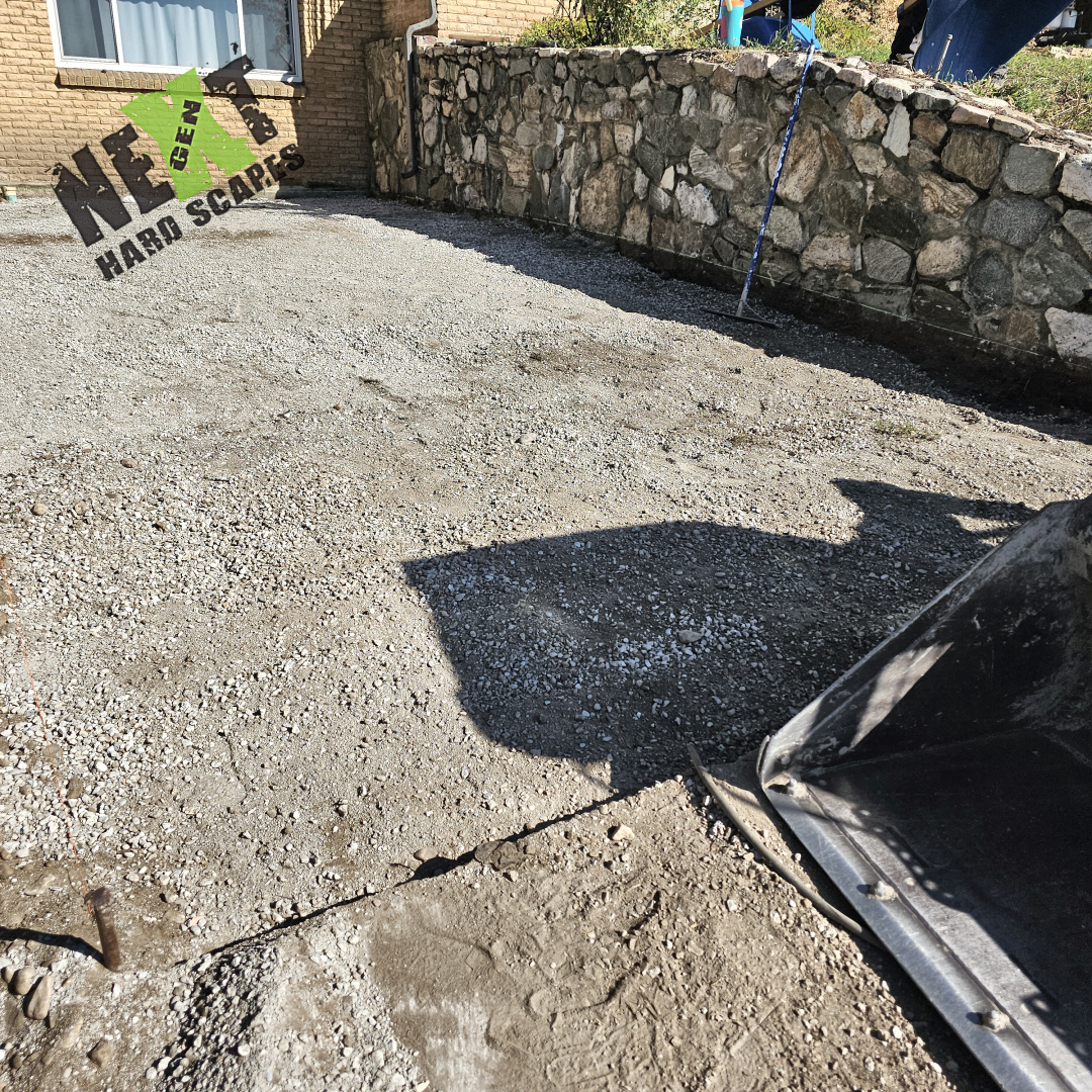 Base layer of compacted gravel installed for the driveway, ensuring strong support and proper drainage.