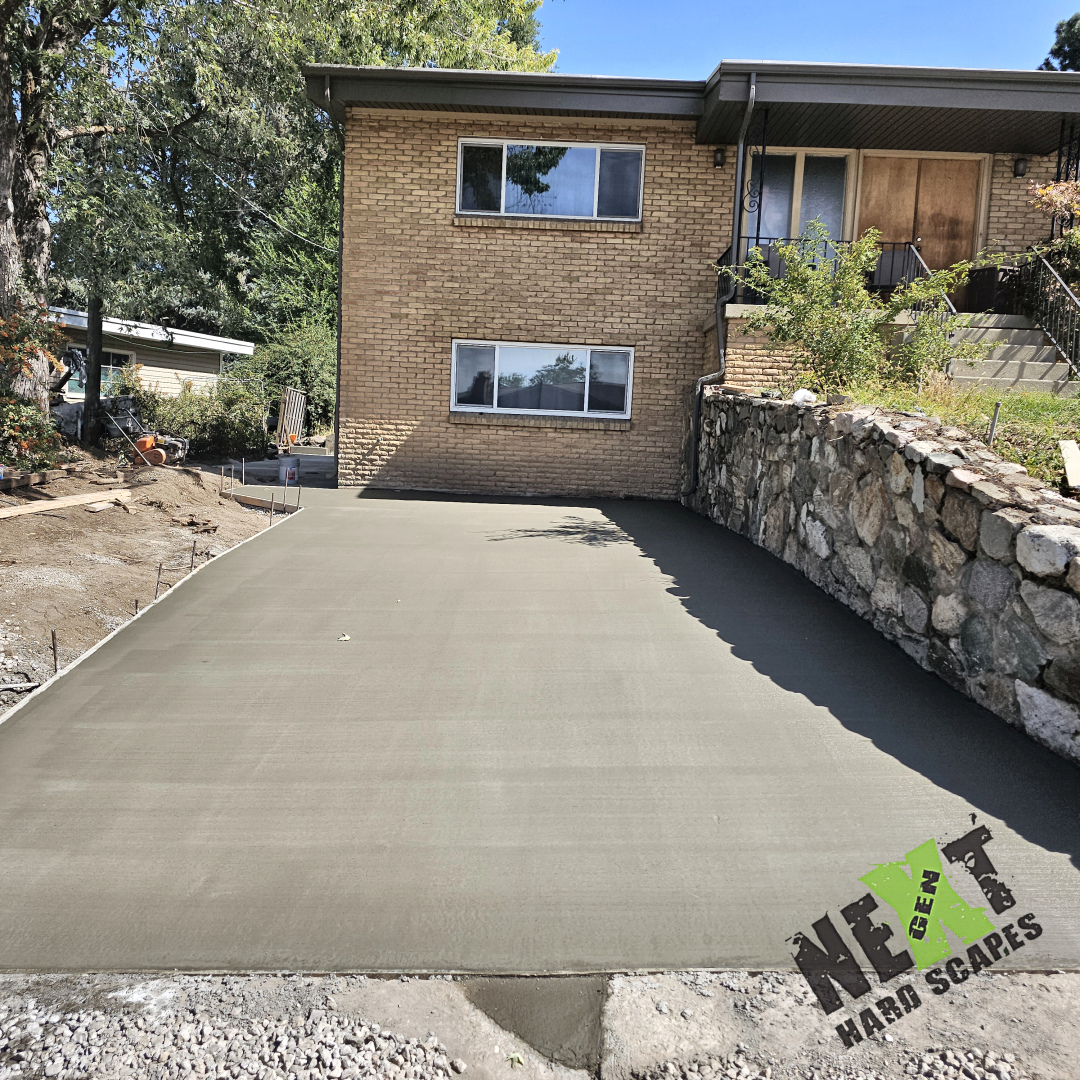 Driveway freshly poured with tight forms and a uniform finish, demonstrating meticulous layout and craftsmanship.