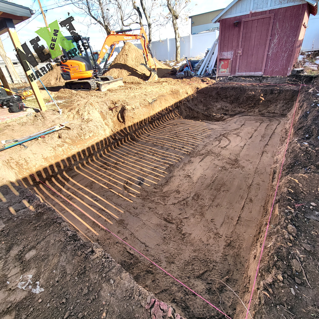 Bobcat equipment on site used for dirt removal and site grading with visible heavy track marks in cleared soil. Bobcat equipment on site used for dirt removal and site grading with visible heavy track marks in cleared soil.