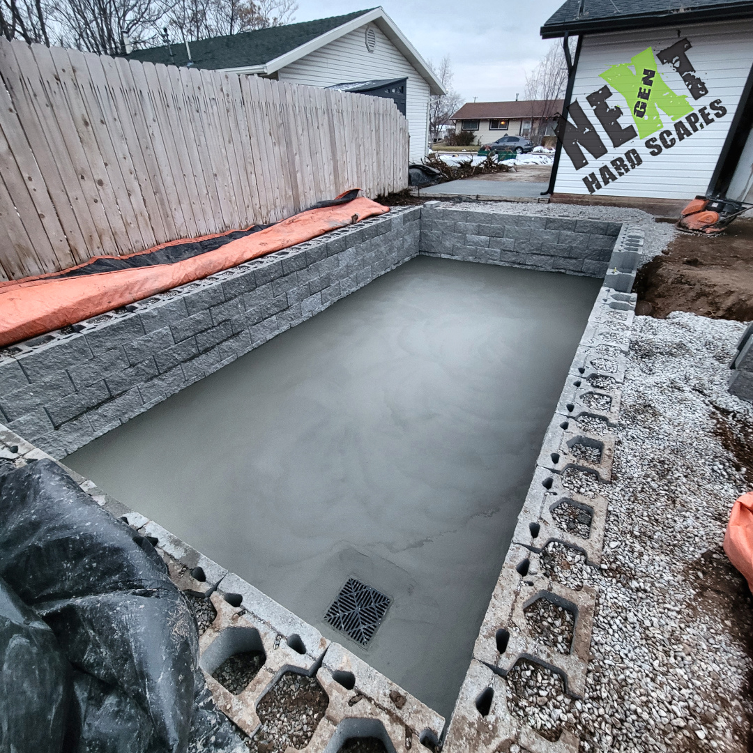 Freshly poured and smooth concrete slab forming the base of the swim spa next to the house. Freshly poured and smooth concrete slab forming the base of the swim spa next to the house.