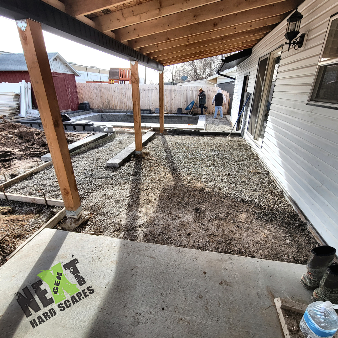 Gravel base spread under covered patio area in preparation for concrete slab and paver installation. Gravel base spread under covered patio area in preparation for concrete slab and paver installation.