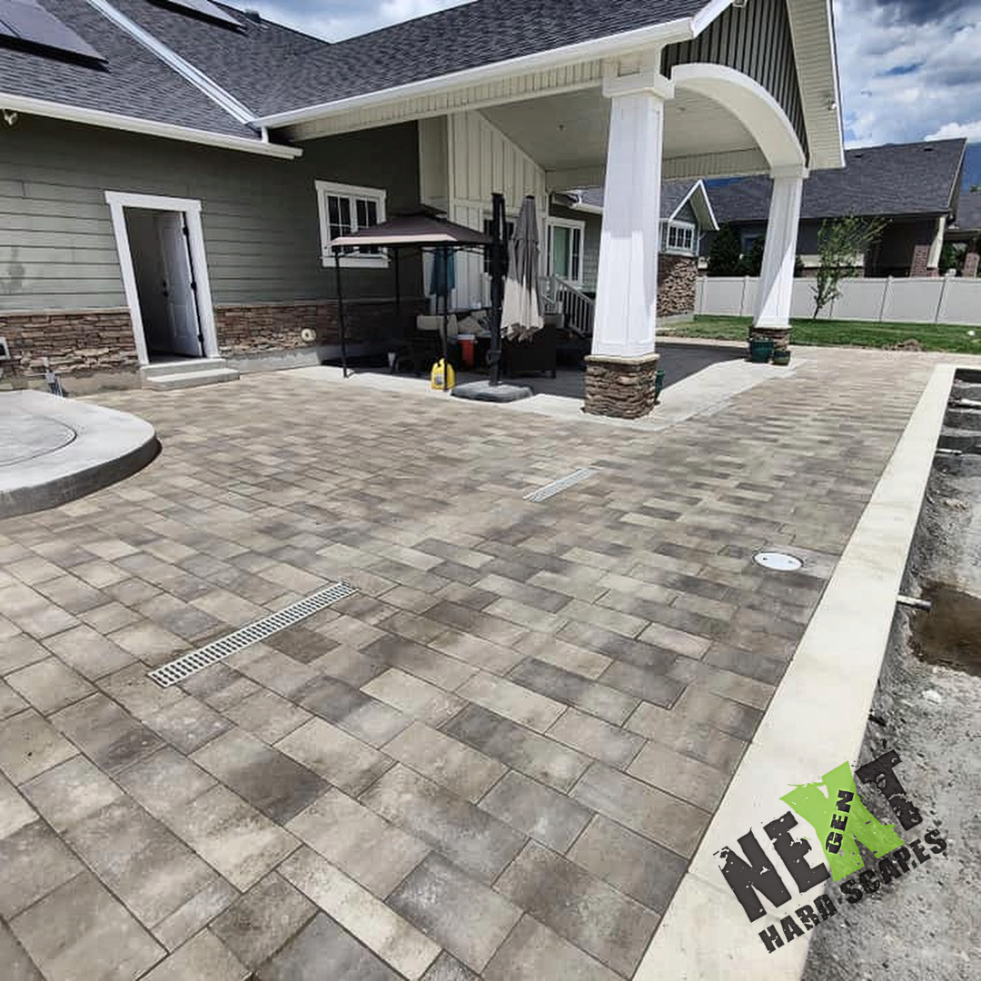 Interlocking pavers installed with consistent joint spacing and two linear drains for effective water runoff. Interlocking pavers installed with consistent joint spacing and two linear drains for effective water runoff.