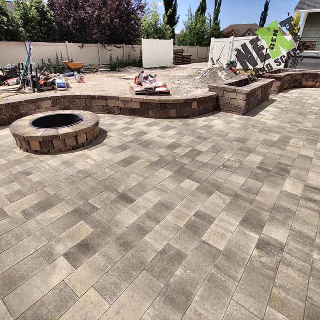 Retaining wall bench and fire pit partially constructed with blockwork matching the paver color palette. Retaining wall bench and fire pit partially constructed with blockwork matching the paver color palette.