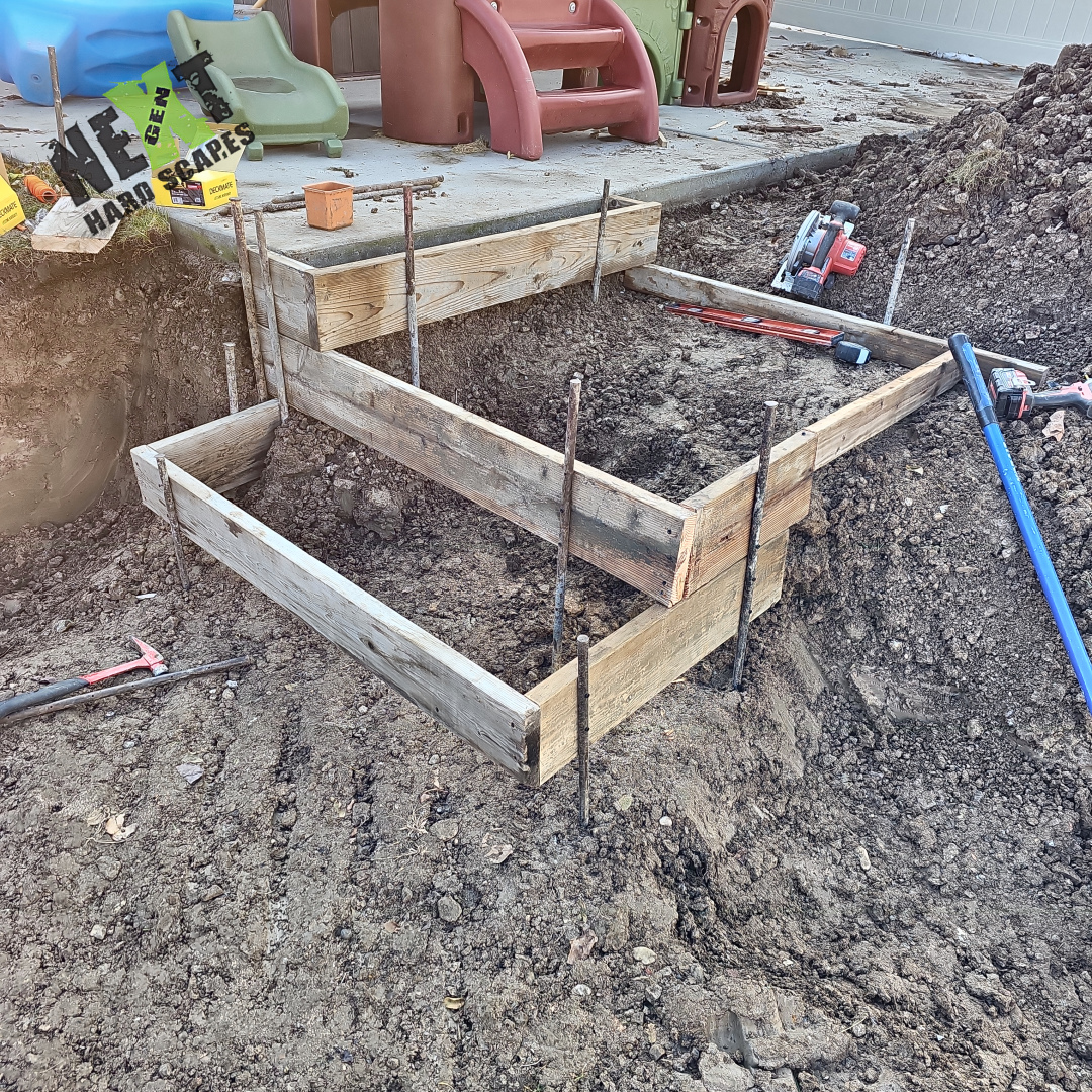 Wood forms and form ties set for the next concrete pour where the step landing will be cast to match the patio elevation. Wood forms and form ties set for the next concrete pour where the step landing will be cast to match the patio elevation.