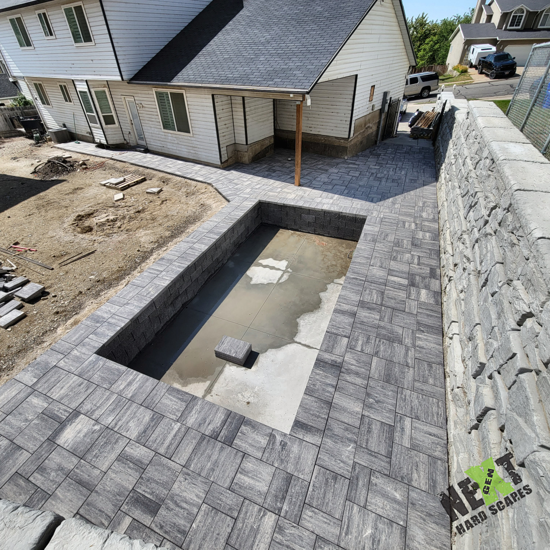 A view from the above with the completed stone deck, walk way, and patio to the front driveway A view from the above with the completed stone deck, walk way, and patio to the front driveway
