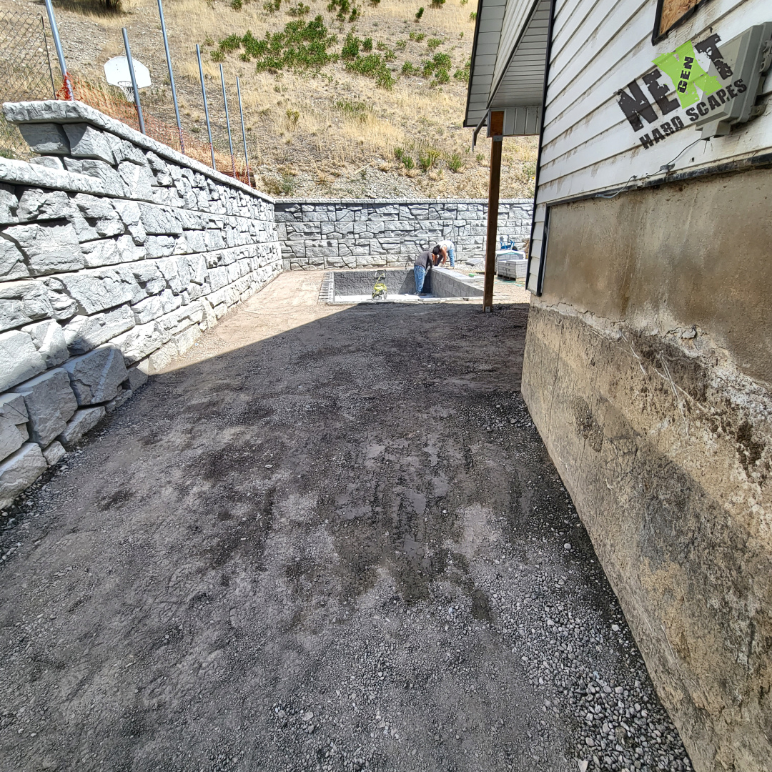 Full image of the backyard grading against the retaining wall for the swim spa recess. Full image of the backyard grading against the retaining wall for the swim spa recess.