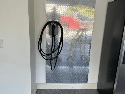 High-speed Level 2 home EV charging station cleanly mounted and wired on a garage wall in a Canton residence.