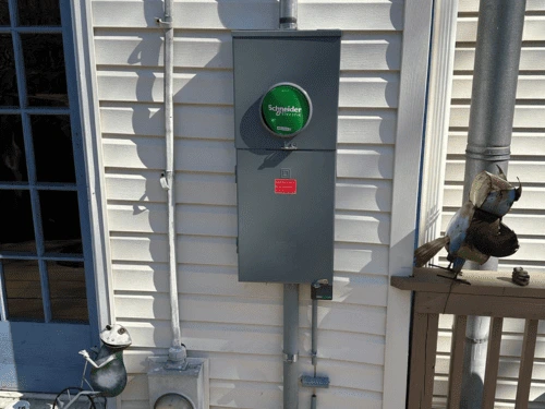Brand new, code-compliant outdoor electrical meter base and disconnect box cleanly mounted to a Woodstock home.