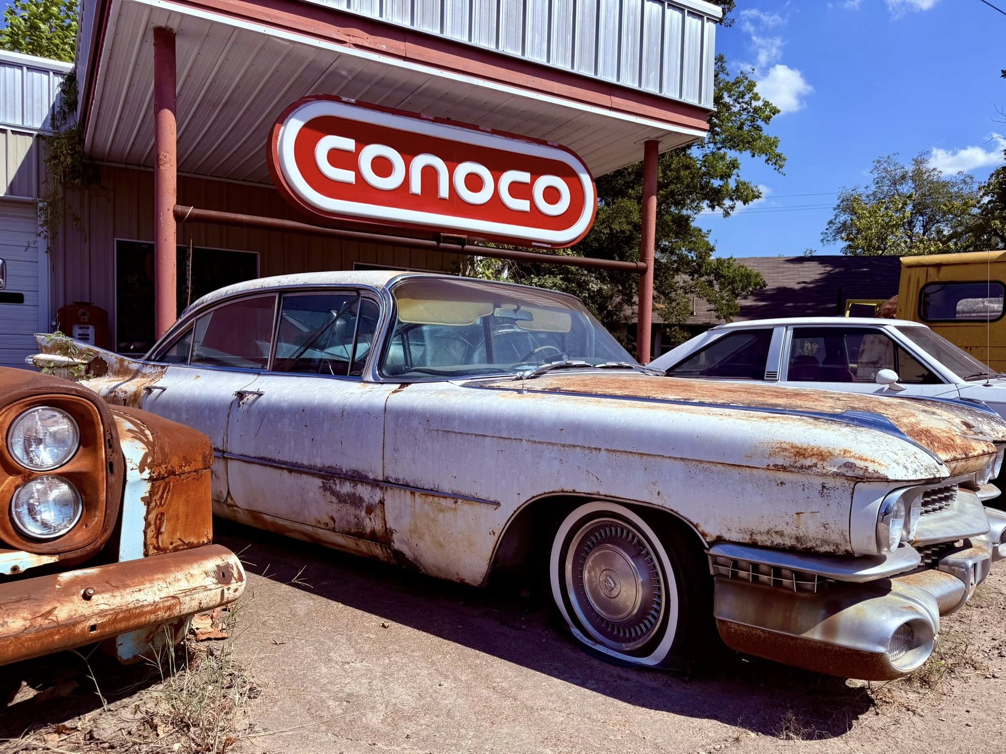 An old Conoco station and vintage car