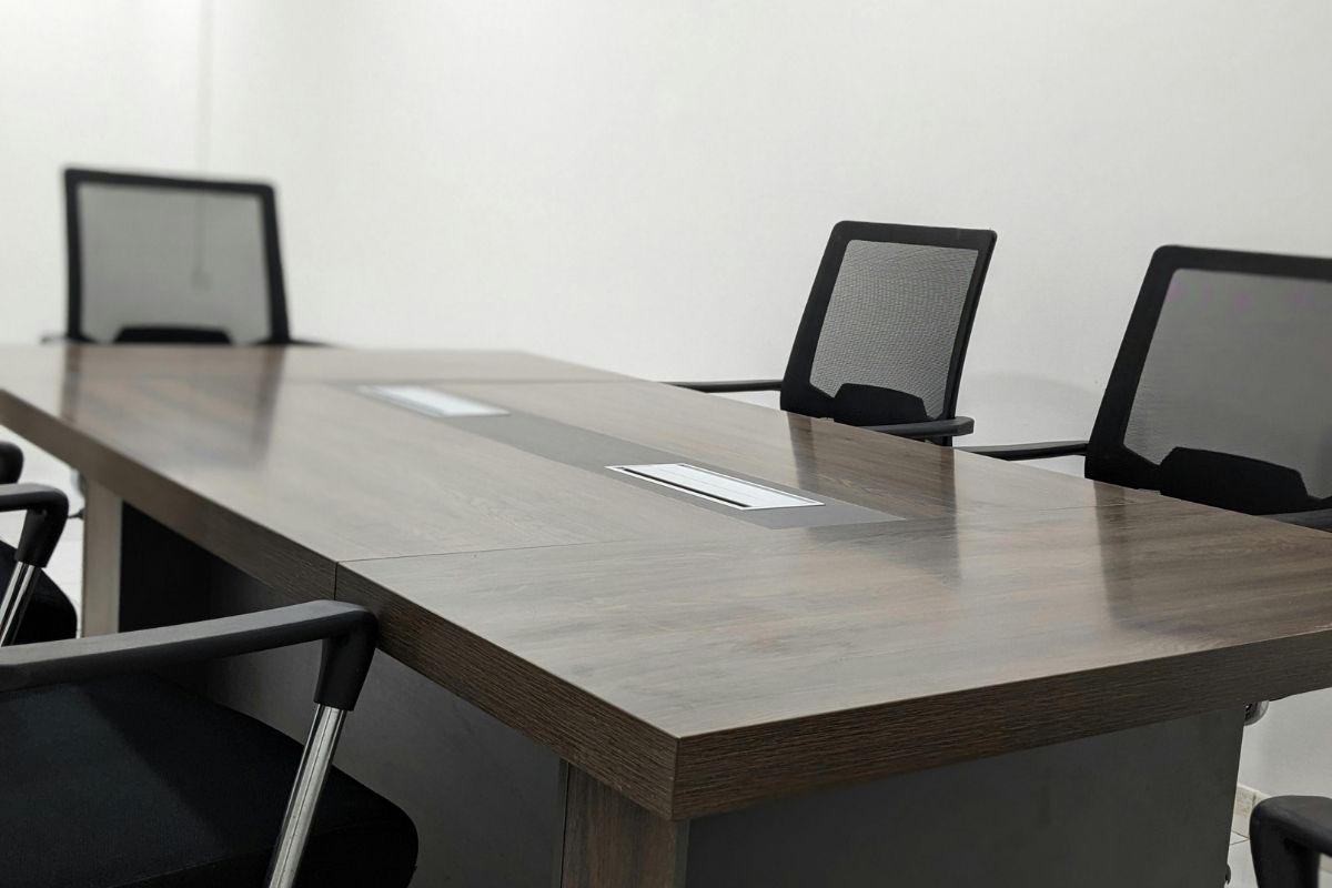 An empty chair at a conference table.
