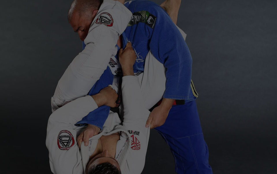 Two adult martial artists sparring in Brazilian Jiu-Jitsu at Musa Sherwood Martial Arts.