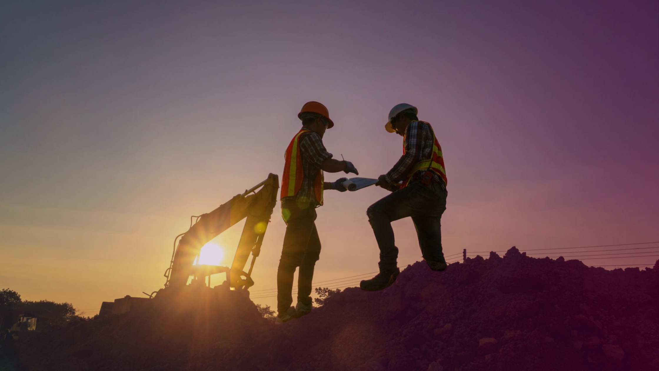 Construction workers reviewing work on site with machinery in the background, representing human judgement and decision-making in workplace safety Construction workers reviewing work on site with machinery in the background, representing human judgement and decision-making in workplace safety