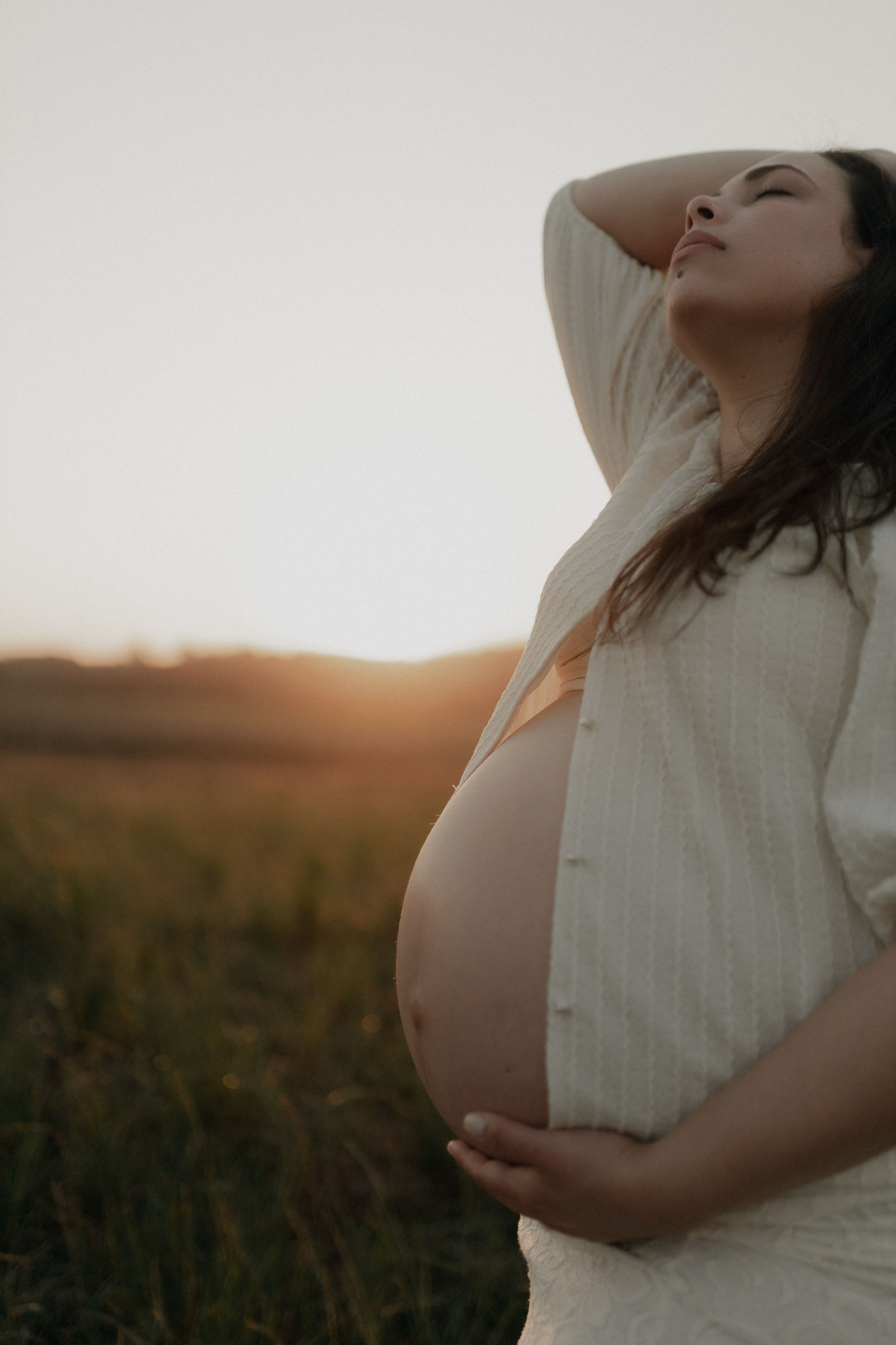 Warm, natural-light photo of a pregnant mom