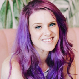 Cathy Olson in 2017, before she knew what a sales funnel was — a headshot with purple hair.