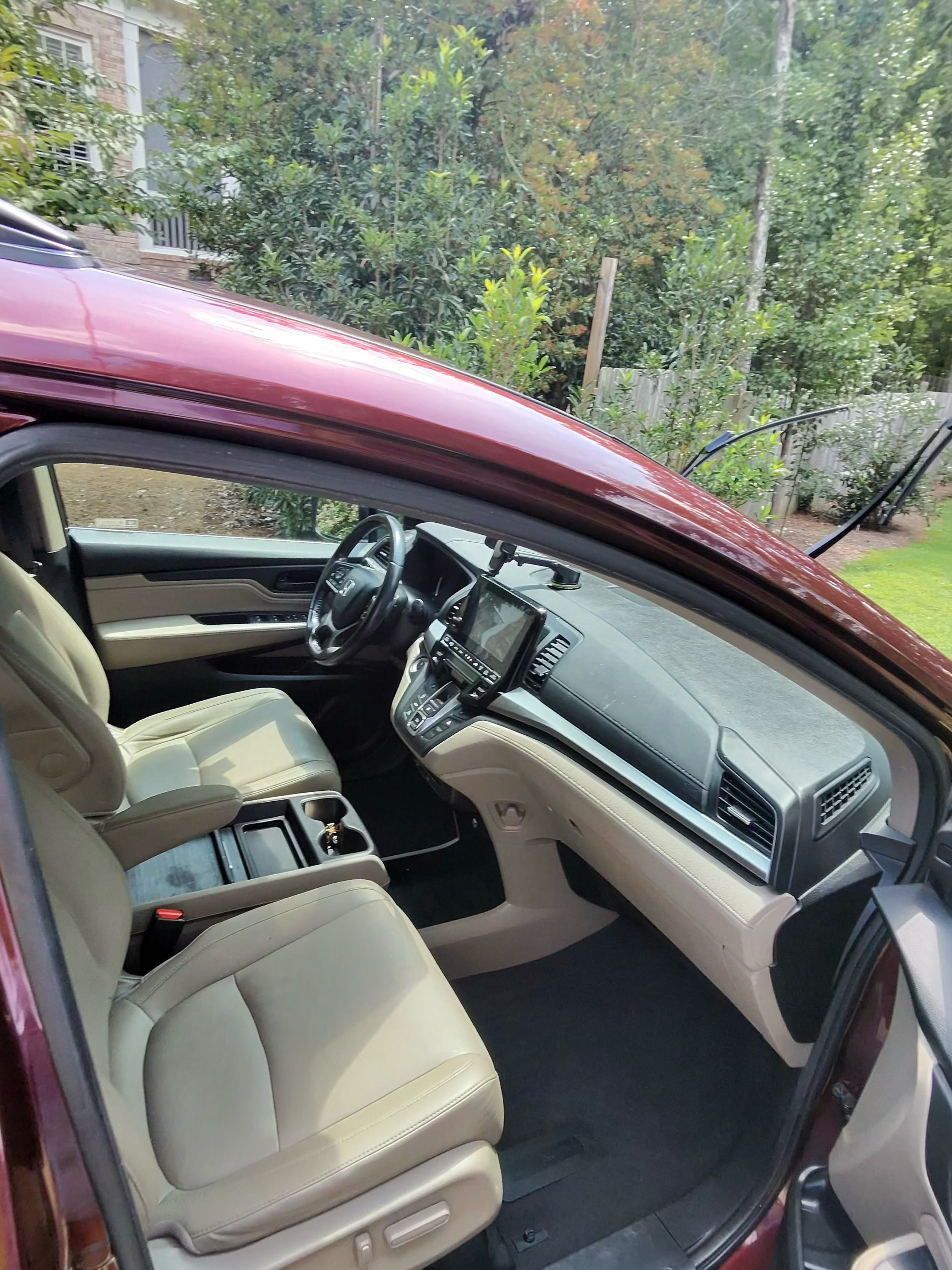 Red car interior with clean dashboard, touchscreen, and steering wheel