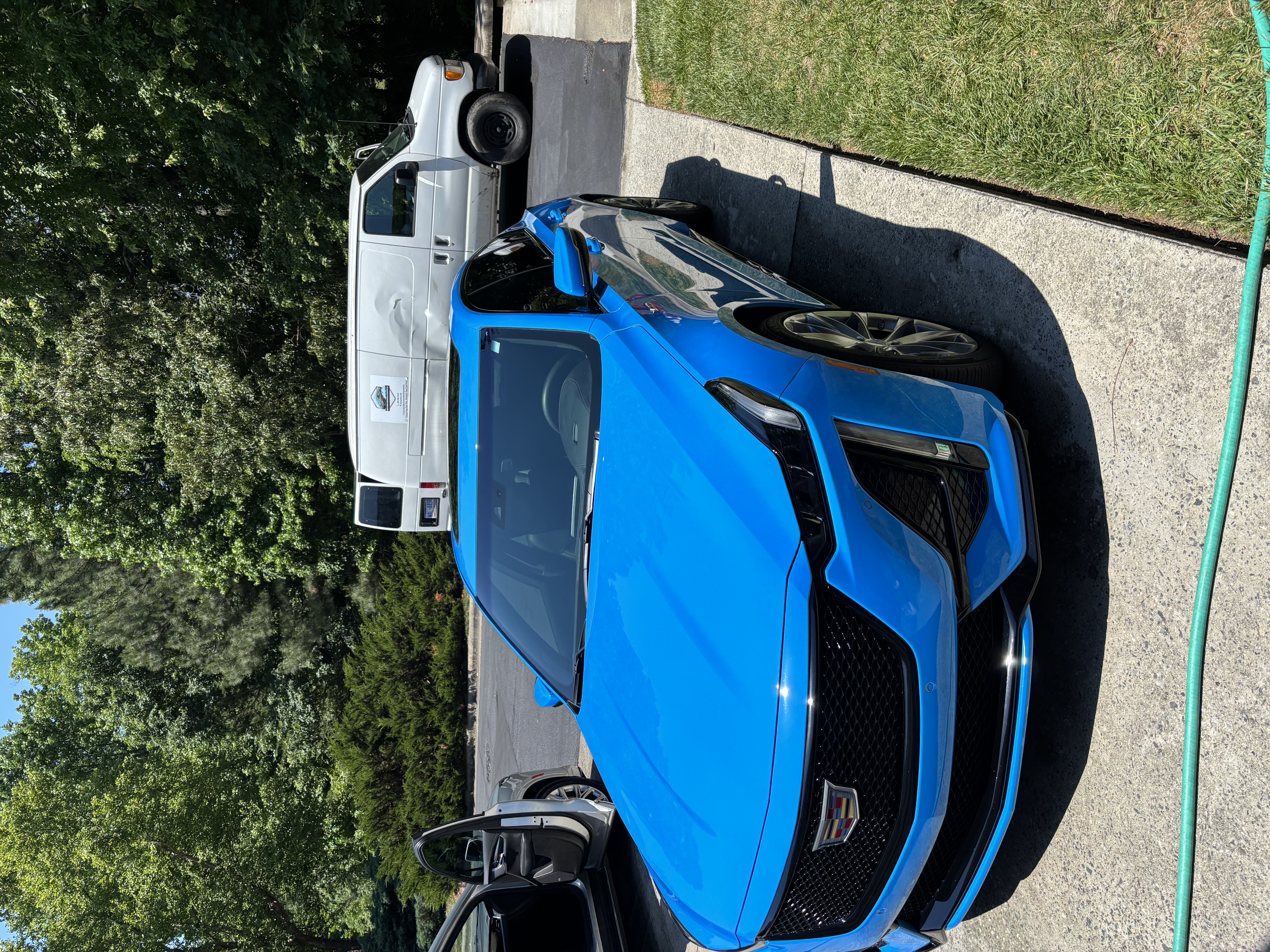 Blue Cadillac detailed and parked in a lot