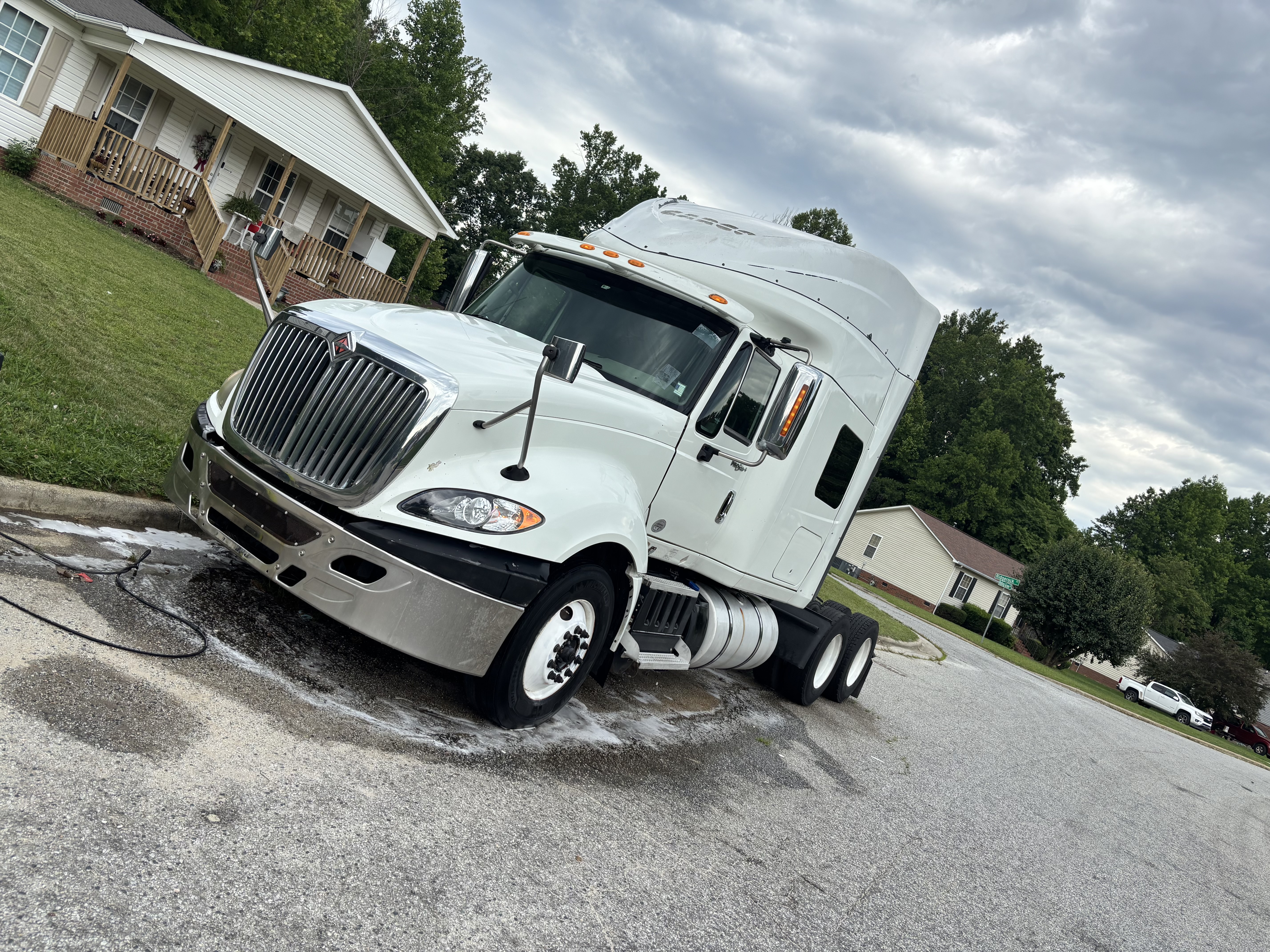 White truck detailed and parked in a residential area