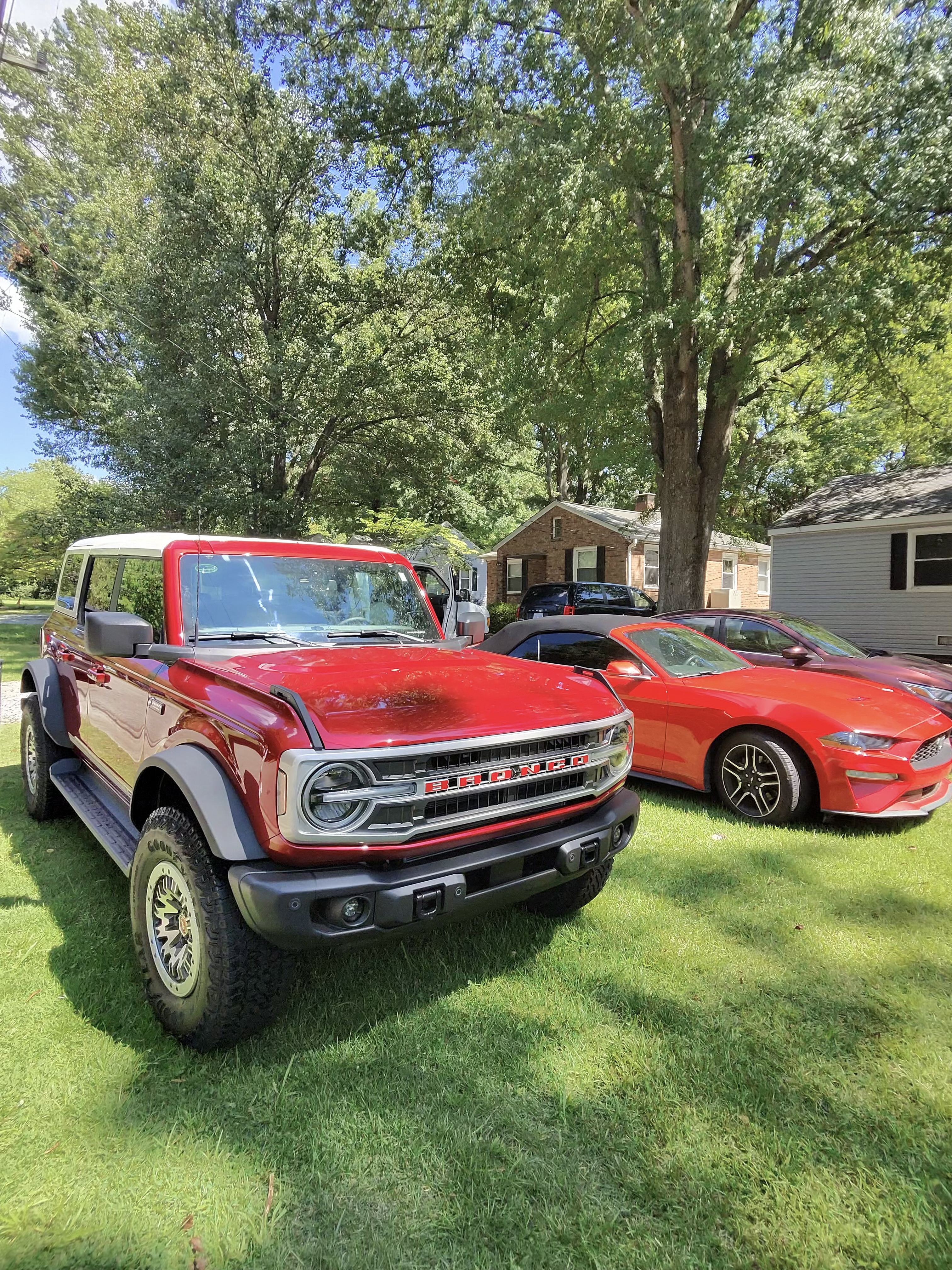 Red Ford Bronco parked on a lawn after exterior detailing