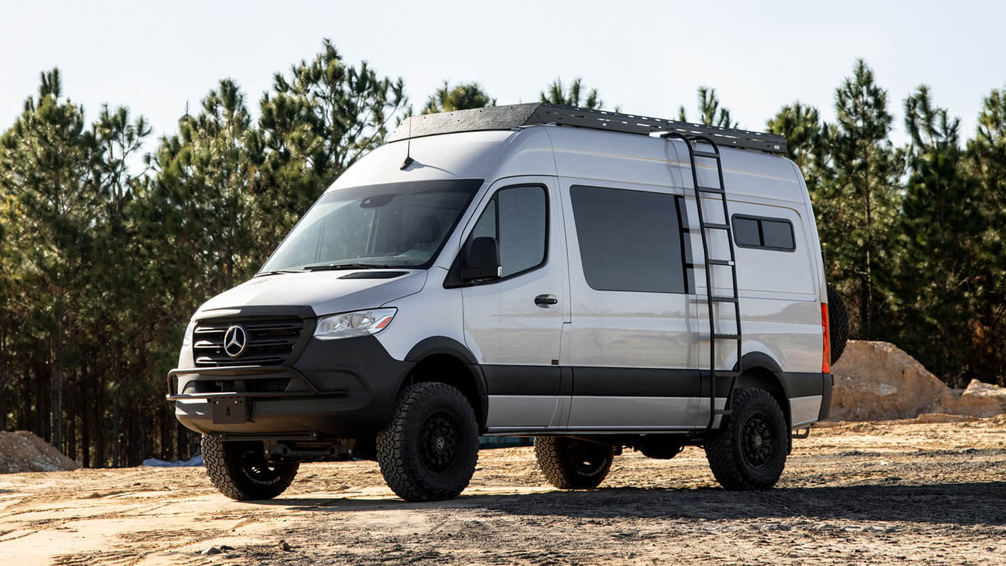 Accessorised van with roof rack parked by the sea
