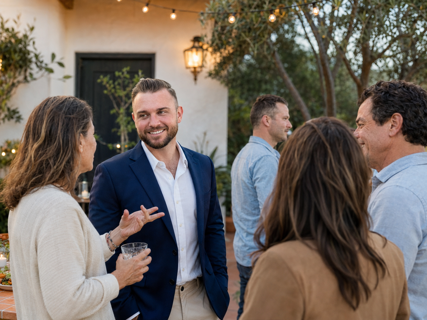 Candidate speaking with a small group at an outdoor neighborhood gathering