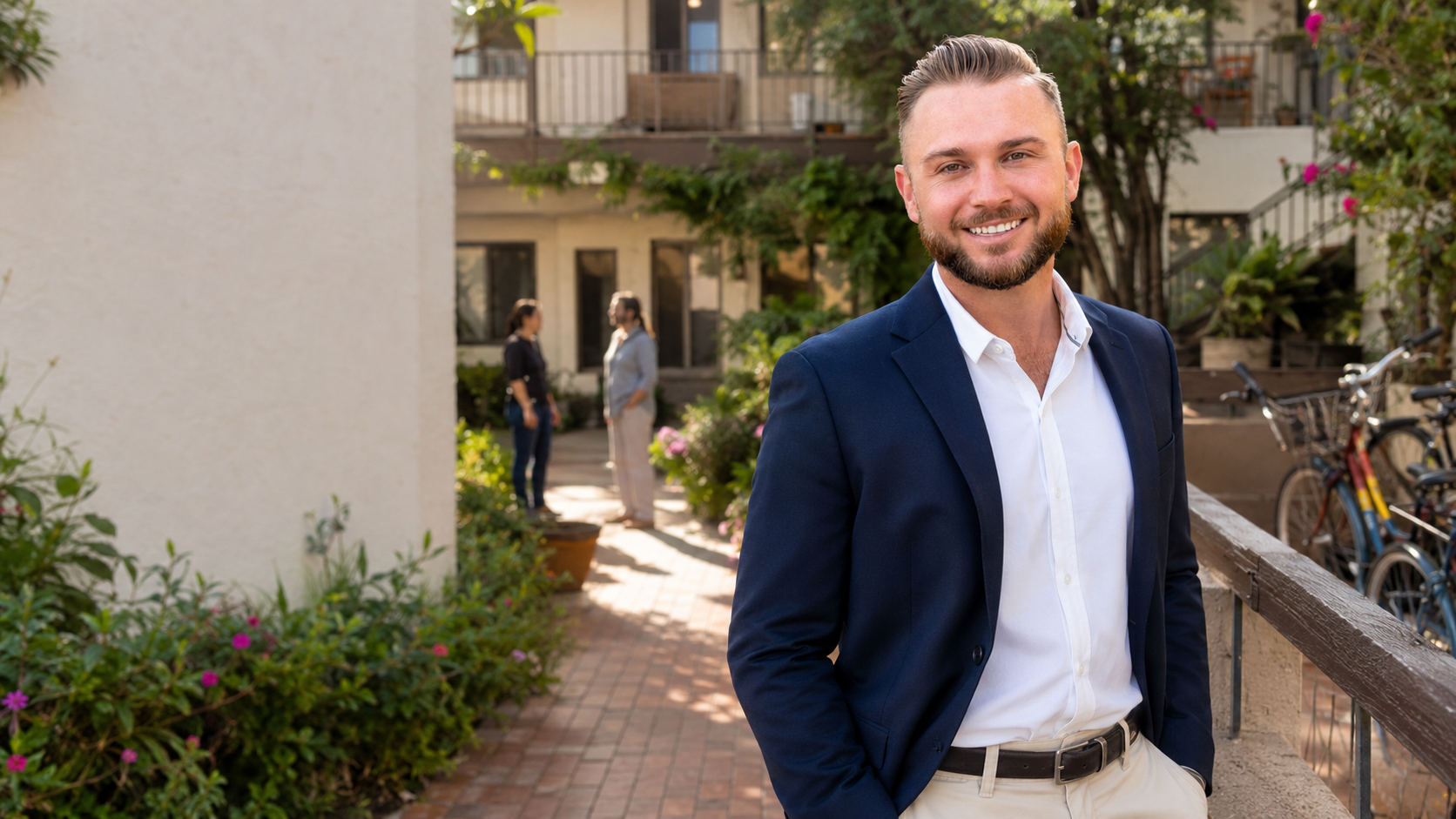 Candidate standing in a landscaped apartment courtyard
