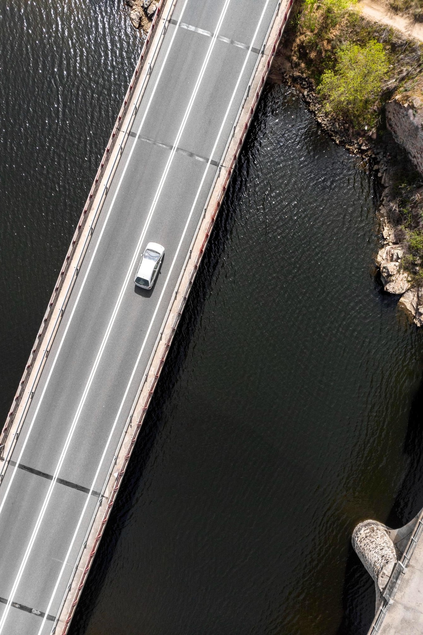 road with car above a river