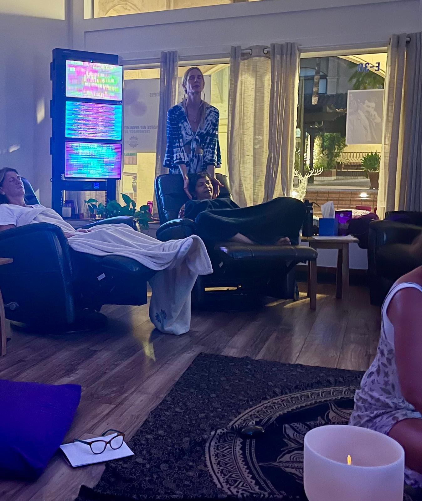 Guests resting in recliners beside the EE System screens