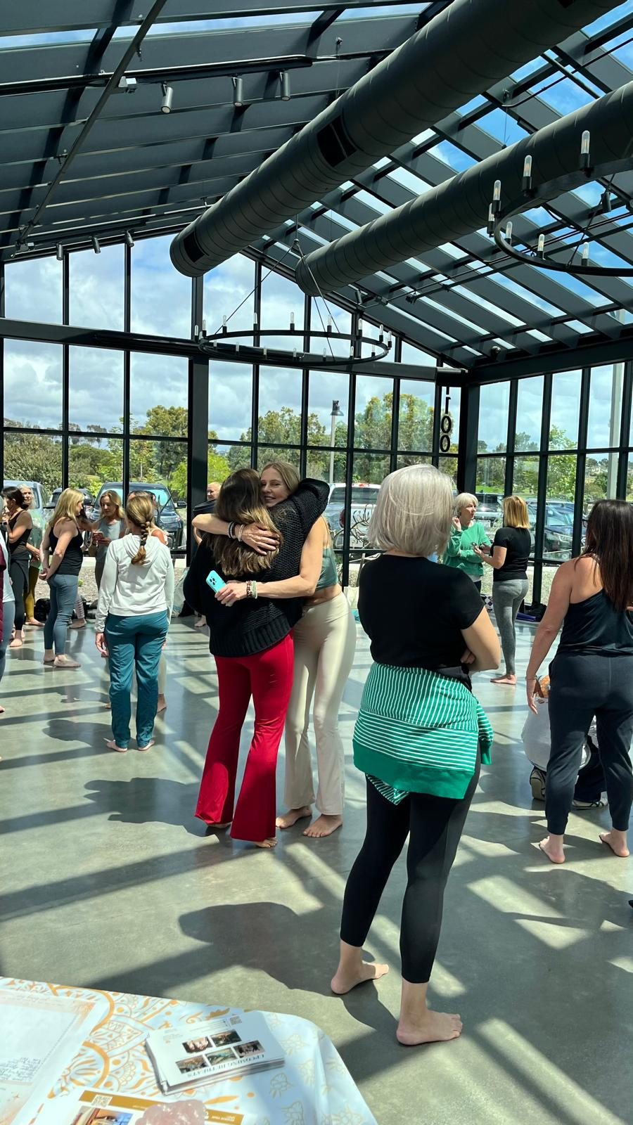 Women embracing inside the glasshouse at Fox Point Farms