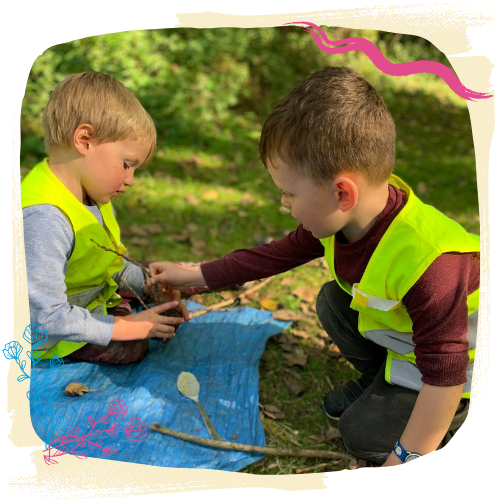 children in high vis playing with sticks