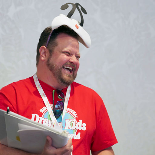 A Drama Kids teacher laughing with the class