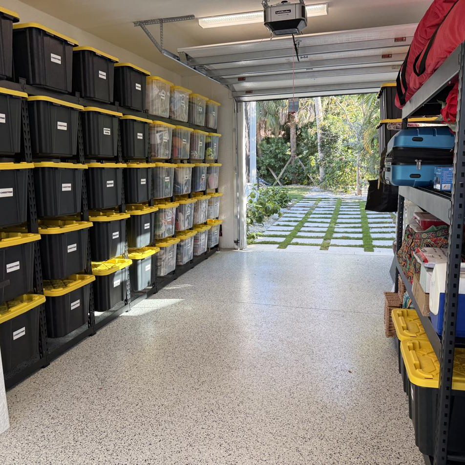 Garage after: wall of labeled totes on heavy-duty racks, clear floor