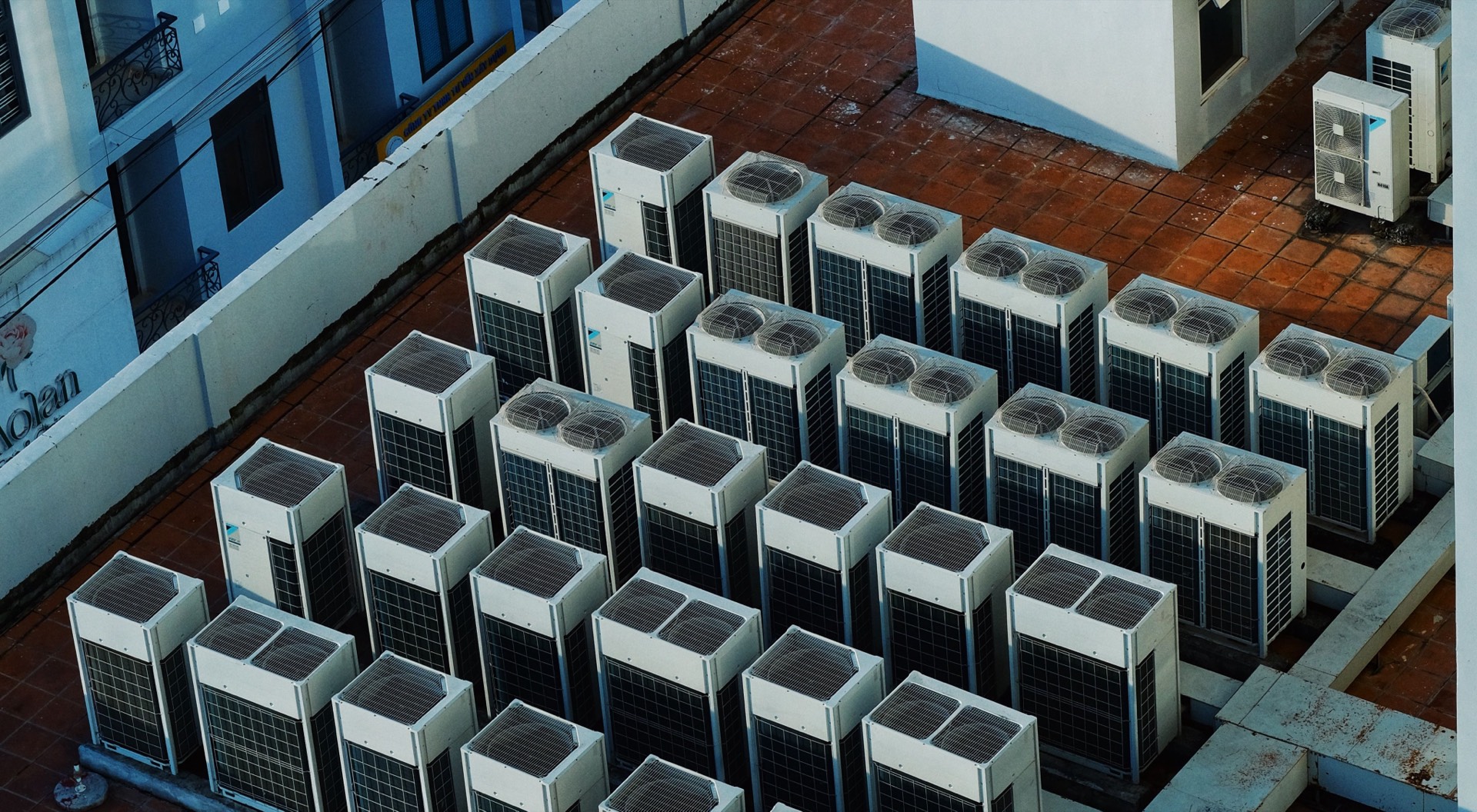 Rows of commercial air conditioning condenser units on a Sandton rooftop