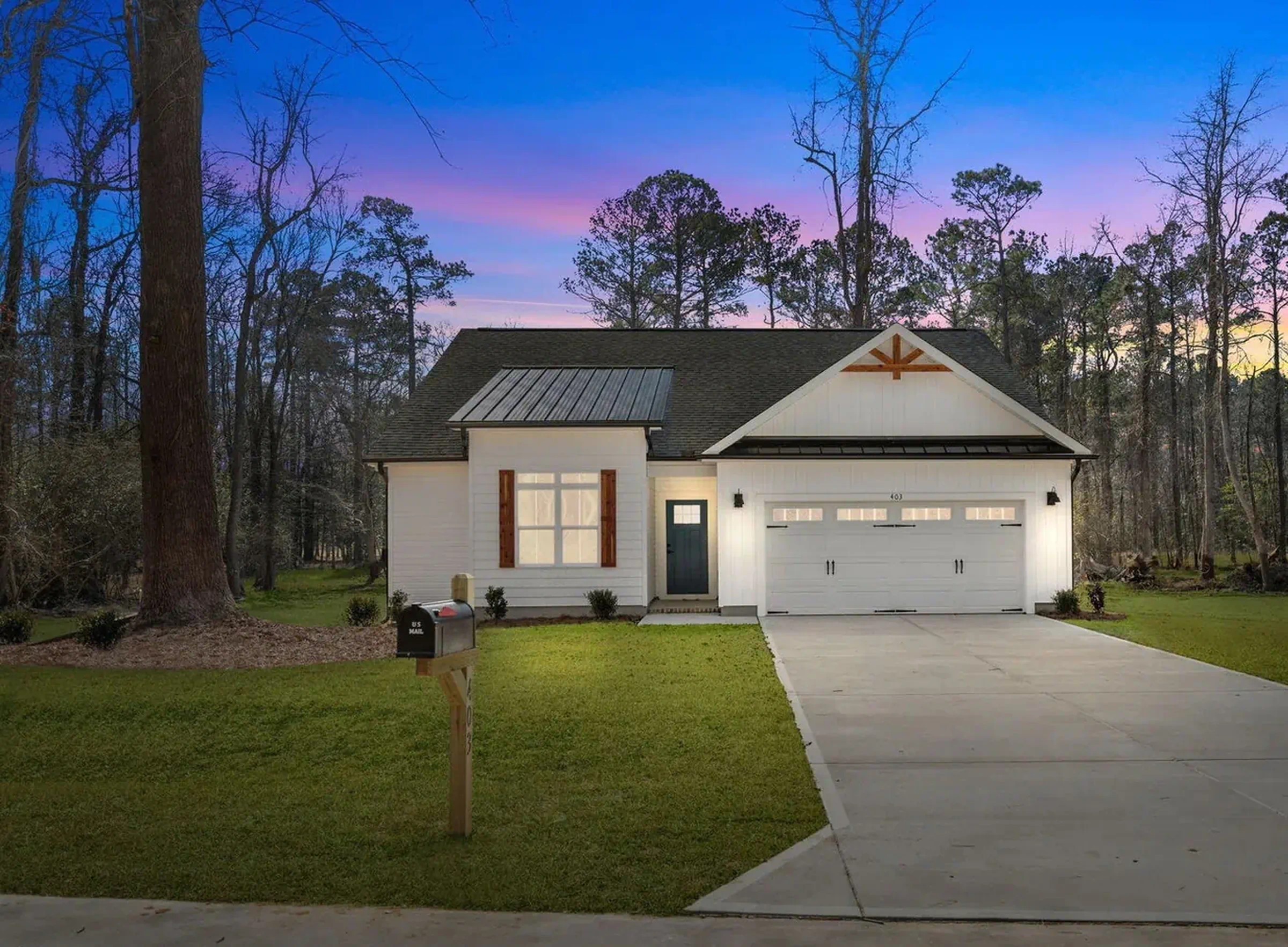 Completed roof and siding on a home surrounded by trees