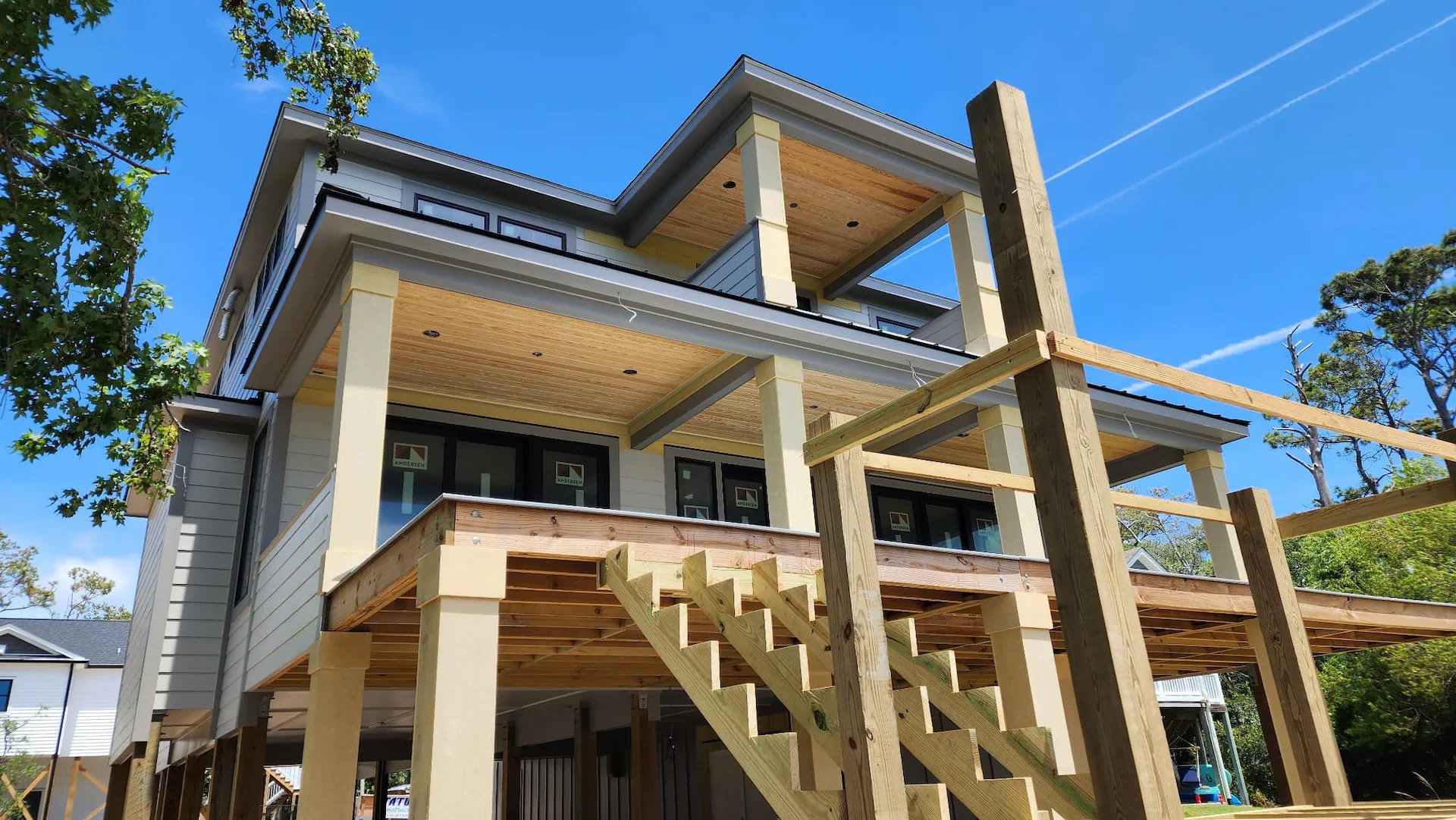 Raised coastal home with new exterior porches and stairs