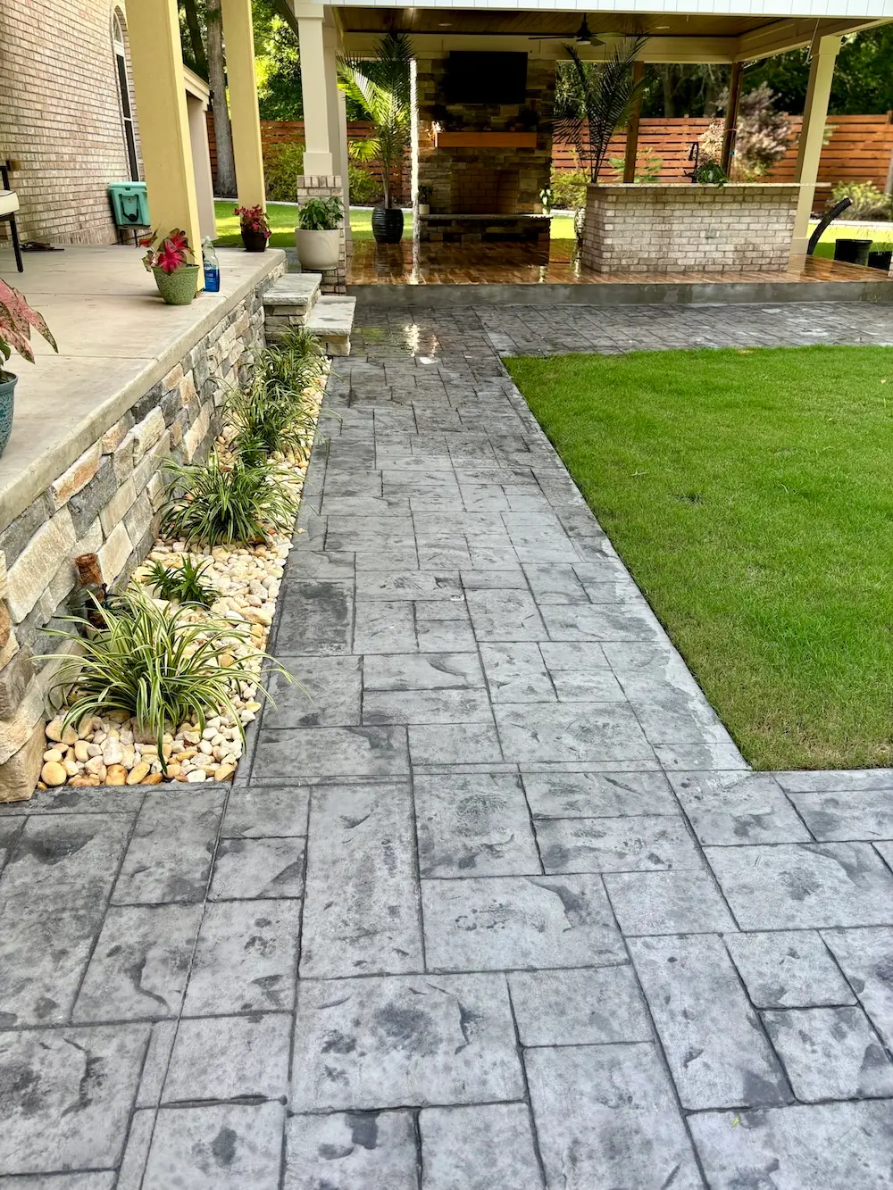 Completed patio and walkway leading to a covered outdoor living space