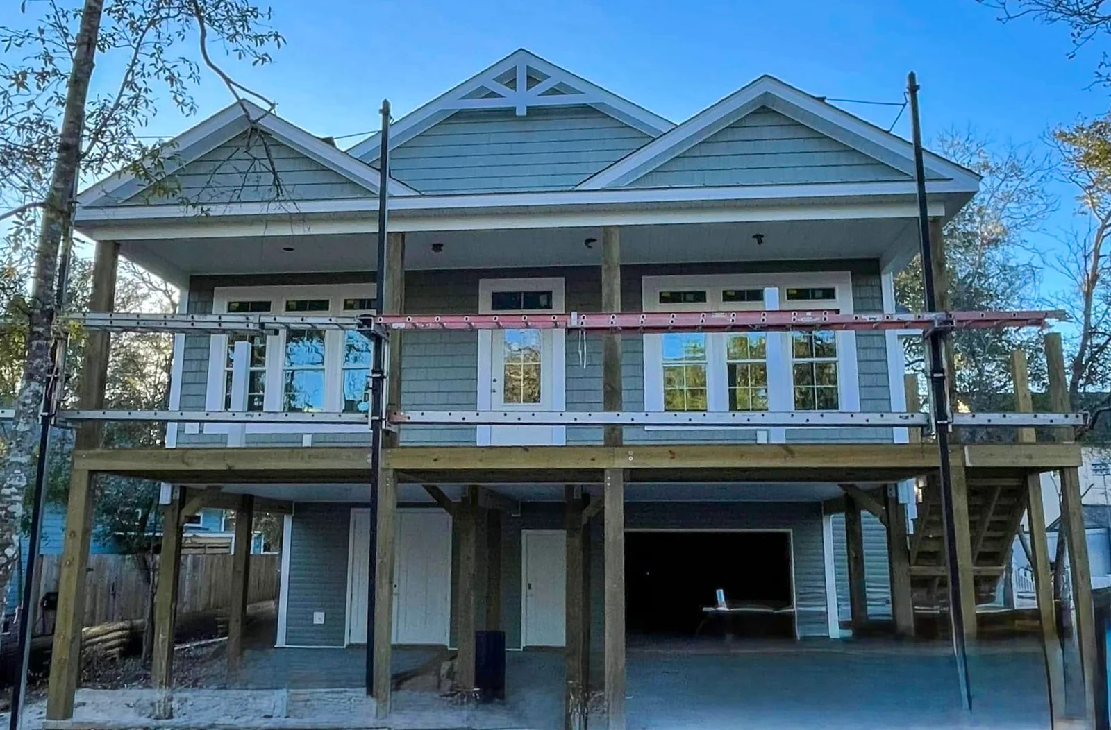 Exterior renovation with a raised porch and new stairs