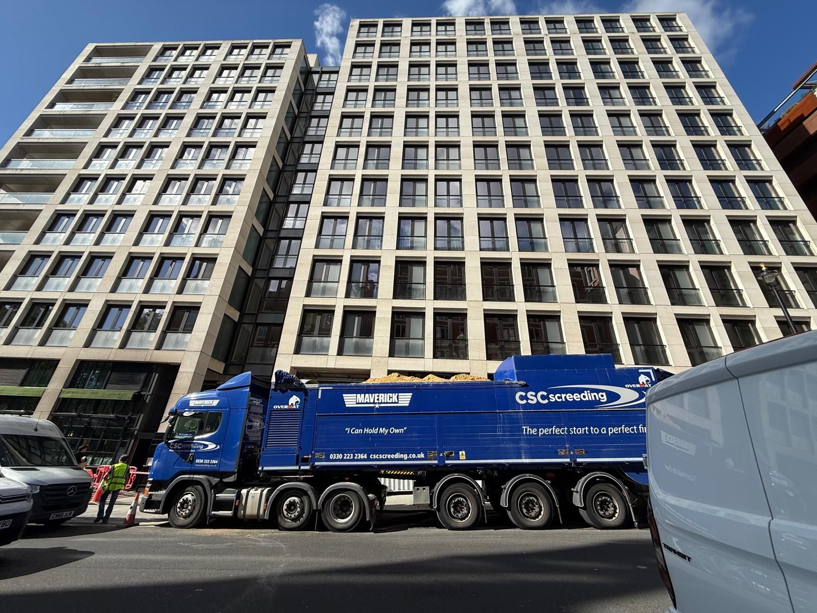 Side view of the full-length Maverick truck beside the Arundel Great Court tower